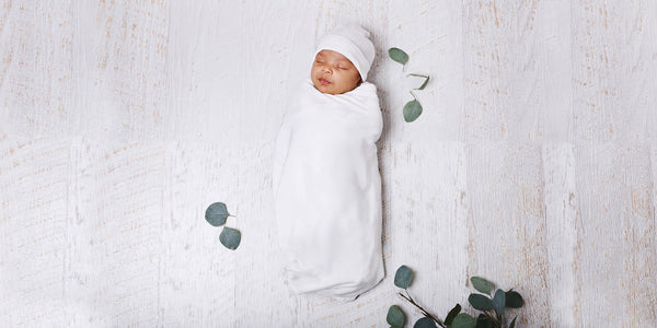 Baby swaddled in organic cotton wrap